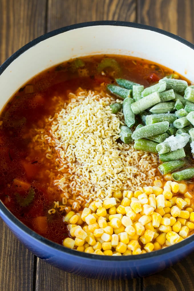 Alphabet Soup Recipe | Hamburger Soup | Beef and Vegetable Soup #soup #hamburger #noodles #dinner #uzhal #carrots A pot with noodles, broth, frozen corn and frozen green beans.