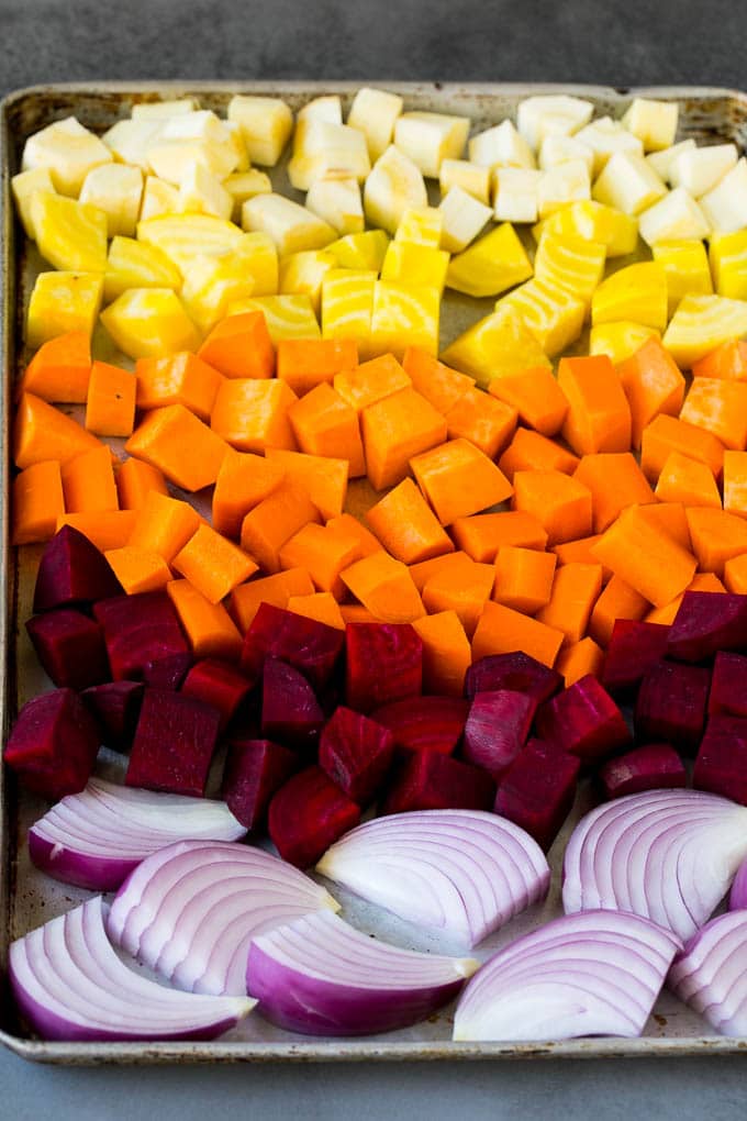 Roasted Root Vegetables Recipe | Roasted Sweet Potatoes | Roasted Beets | Roasted Carrots #carrots #beets #vegetables #sweetpotatoes #fall #parsnips #sidedish #uzhal #cleaneating #healthy Onions, carrots, beets, parsnips and sweet potatoes on a sheet pan.