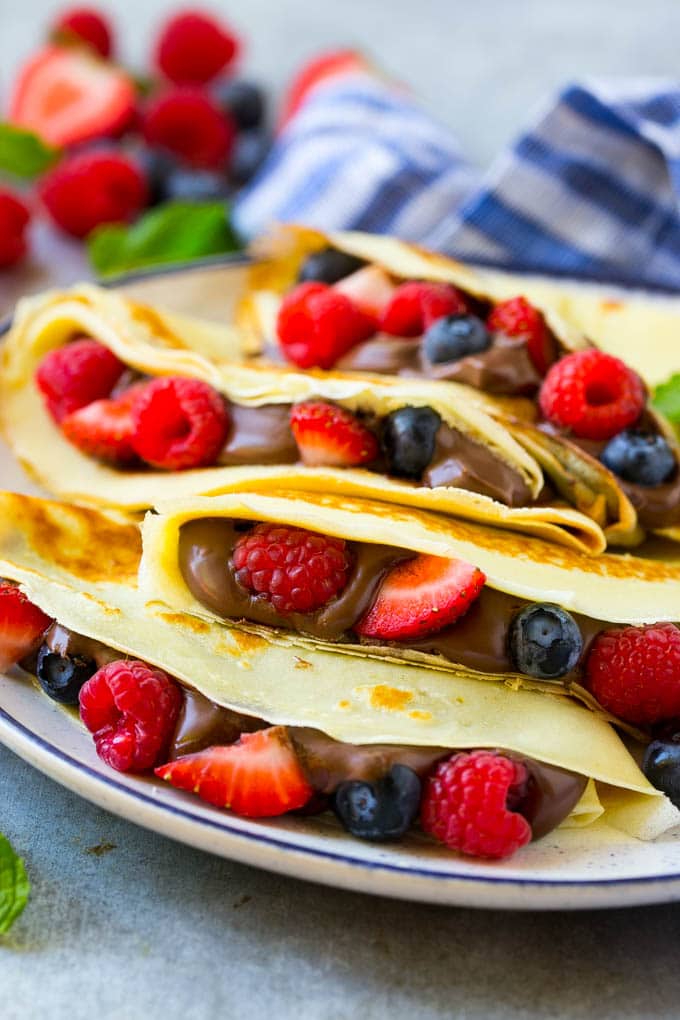Nutella Crepes Recipe | Easy Crepes Recipe | Blender Crepes | Berry Crepes #crepes #nutella #nutellacrepes #blendercrepes #breakfast #uzhal A stack of crepes that are stuffed full of chocolate Nutella spread and fresh berries.