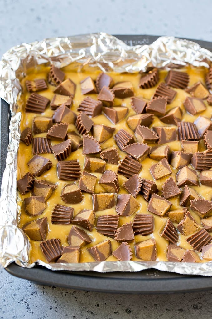 Chocolate Peanut Butter Fudge Recipe | Peanut Butter Cup Fudge | Easy Fudge Recipe #chocolate #peanutbutter #fudge #baking #dessert #uzhal Layered peanut butter chocolate fudge in a square pan.