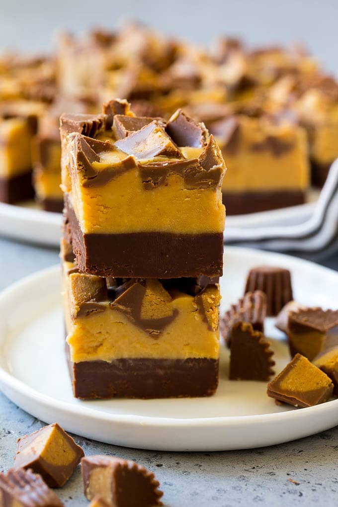 Chocolate Peanut Butter Fudge Recipe | Peanut Butter Cup Fudge | Easy Fudge Recipe #chocolate #peanutbutter #fudge #baking #dessert #uzhal Stacked pieces of chocolate peanut butter fudge on a plate.