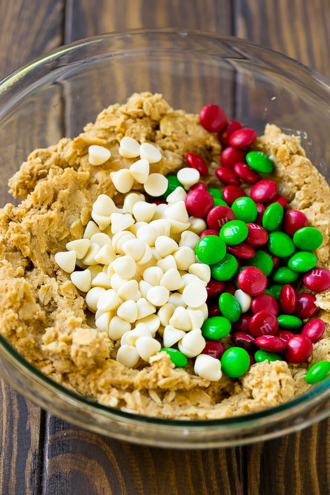 Christmas Monster Cookies Recipe | Oatmeal Cookies | Peanut Butter Cookies | M&M's Cookies #baking #cookies #dessert #peanutbutter #chocolate #uzhal #christmas #sprinkles Cookie dough with red and green M&M's and white chocolate chips.