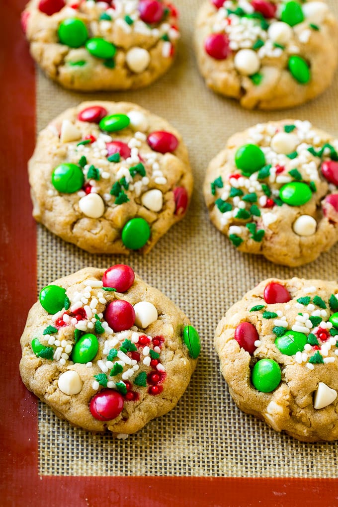 Christmas Monster Cookies Recipe | Oatmeal Cookies | Peanut Butter Cookies | M&M's Cookies #baking #cookies #dessert #peanutbutter #chocolate #uzhal #christmas #sprinkles Baked Christmas cookies on a sheet pan.