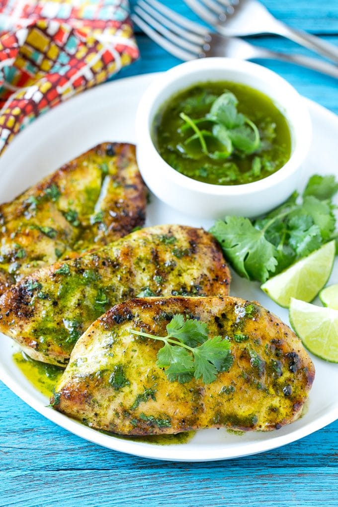 Cilantro Lime Chicken | Grilled Chicken #chicken #grilling #cilantro #lime #dinner #uzhal Cilantro lime chicken topped with sauce and served with lime wedges.