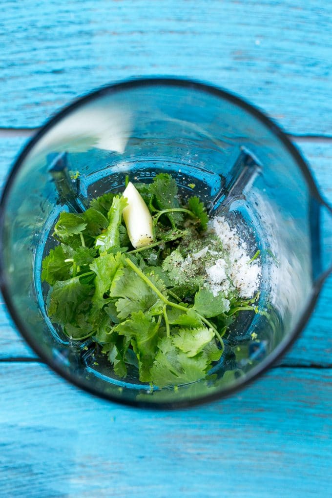 Cilantro Lime Chicken | Grilled Chicken #chicken #grilling #cilantro #lime #dinner #uzhal A blender full of cilantro leaves, garlic, lime juice and olive oil.