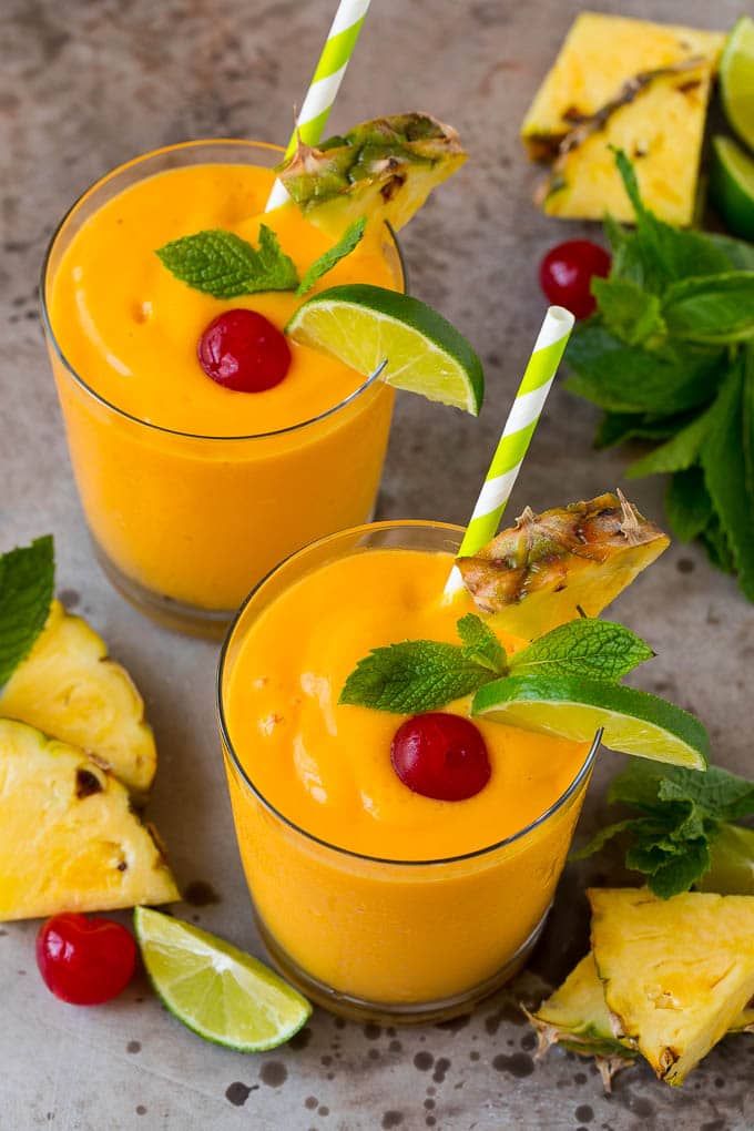Tropical Smoothie Recipe | Mango Smoothie | Pineapple Smoothie #smoothie #mango #pineapple #banana #drink #uzhal Tropical smoothie garnished with mint, limes and pineapple.