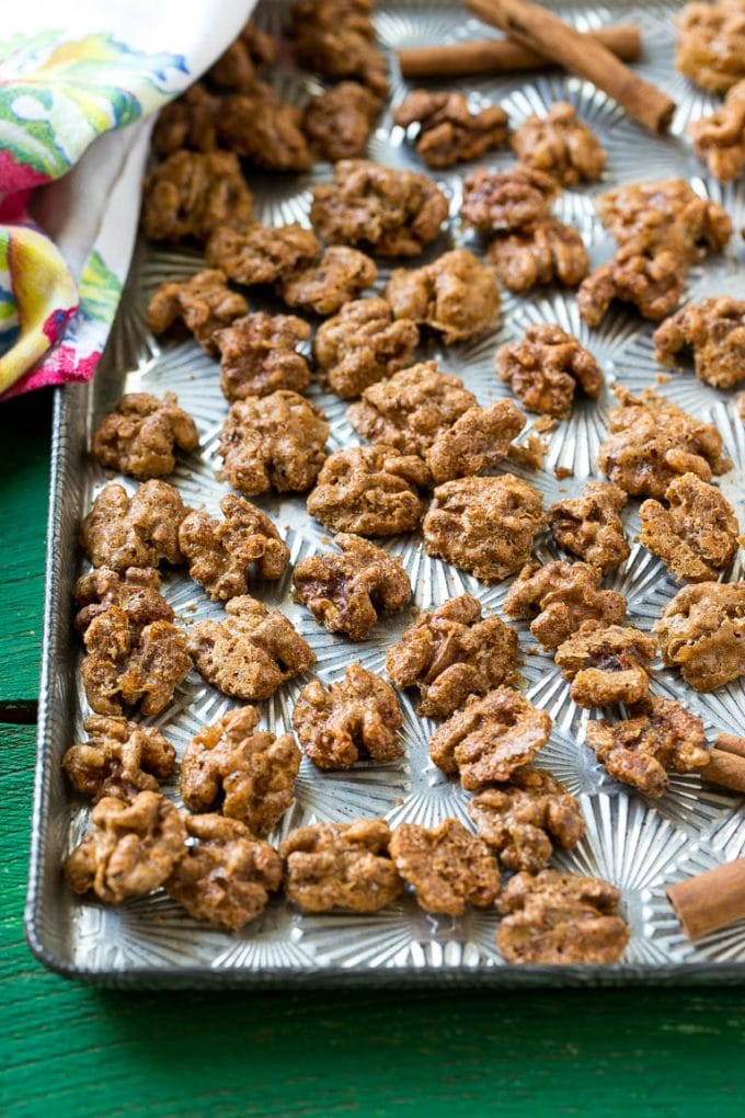Candied Walnuts Recipe | Candied Nuts | Glazed Walnuts | Cinnamon Sugar Walnuts #walnuts #dessert #snack #uzhal A sheet pan with a layer of glazed walnut halves.