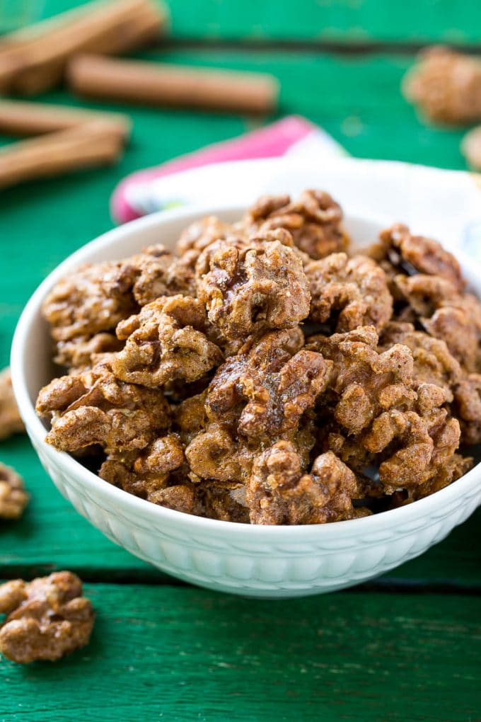 Candied Walnuts Recipe | Candied Nuts | Glazed Walnuts | Cinnamon Sugar Walnuts #walnuts #dessert #snack #uzhal A white bowl filled with candied walnuts.