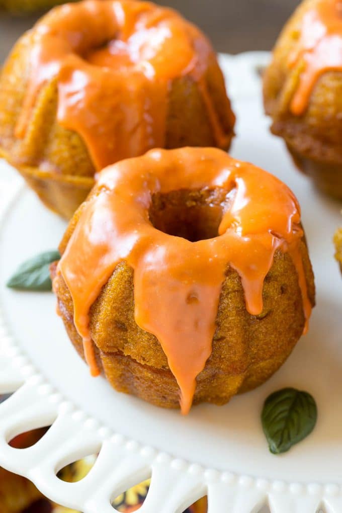 Pumpkin Spice Cake Recipe | Pumpkin Cake | Easy Pumpkin Cake | Thanksgiving Dessert #thanksgiving #pumpkin #cake #pumpkincake #spicecake #dessert #uzhal #holiday Two bundt cakes stacked together with orange colored ganache on top.