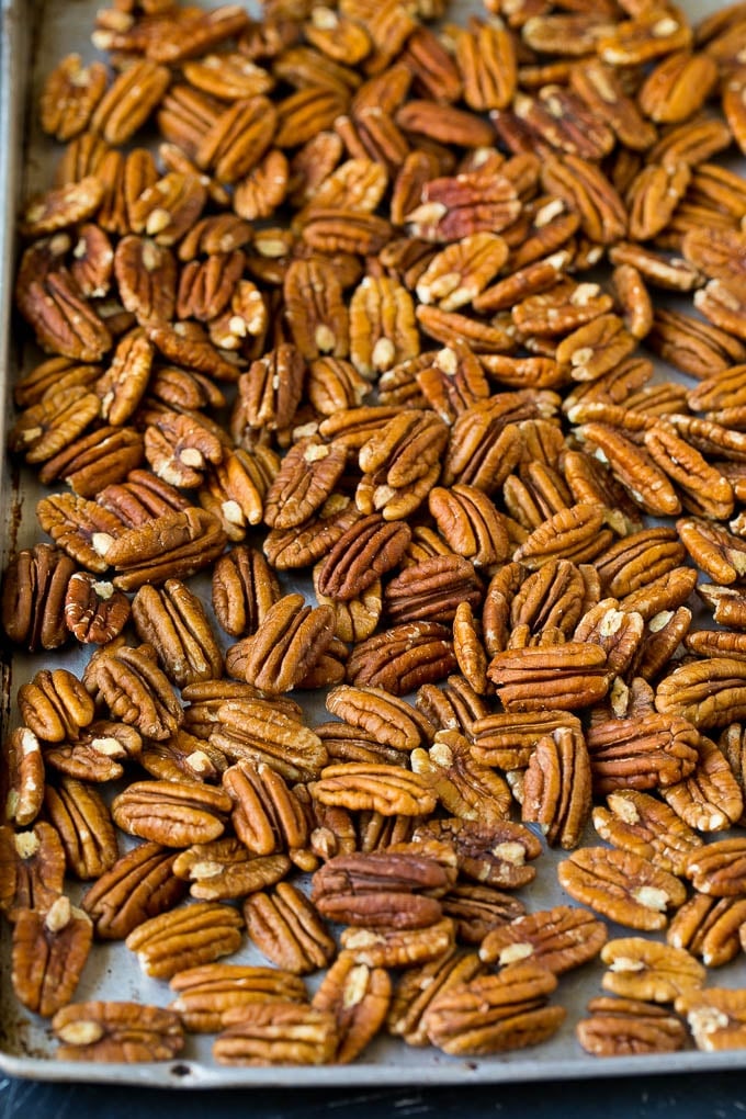 Candied Pecans Recipe | Glazed Pecans | Sugared Pecans #pecans #nuts #snack #dessert #uzhal Pecan halves on a sheet pan.