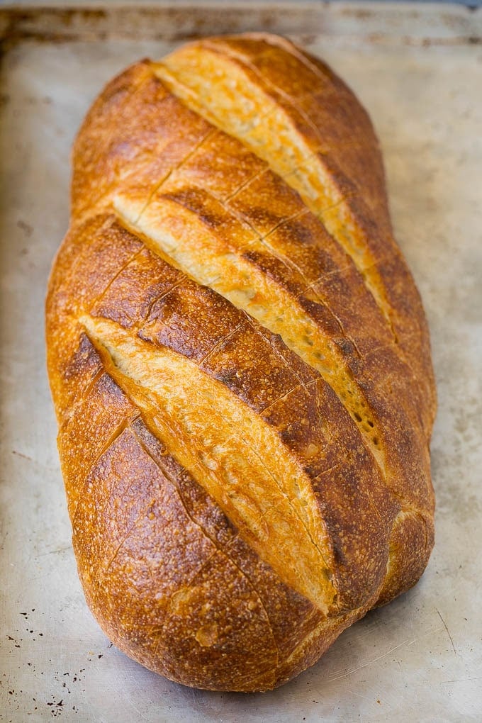 Pull Apart Bread | Garlic Bread | Cheese Bread #bread #garlic #cheese #sidedish #appetizer #uzhal A loaf of bread on a sheet pan with diagonal cuts in it.