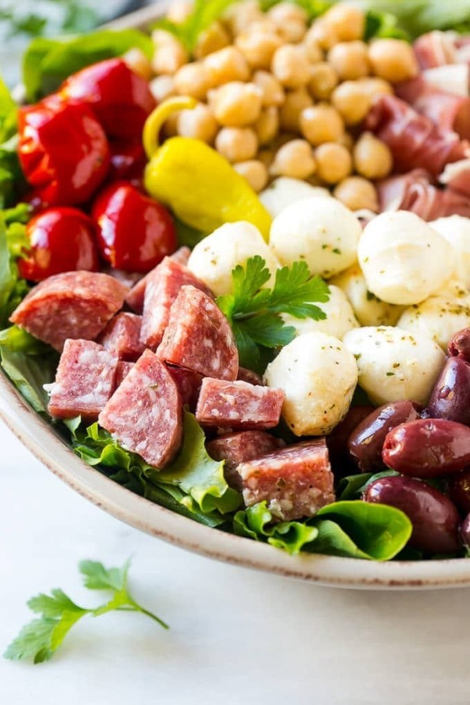 Antipasto Salad Recipe | Italian Salad | Main Course Salad | Antipasto Recipe #salad #salami #italianfood #dinner #lunch #uzhal A bed of greens topped with antipasto salad including meats, cheeses, beans and vegetables.