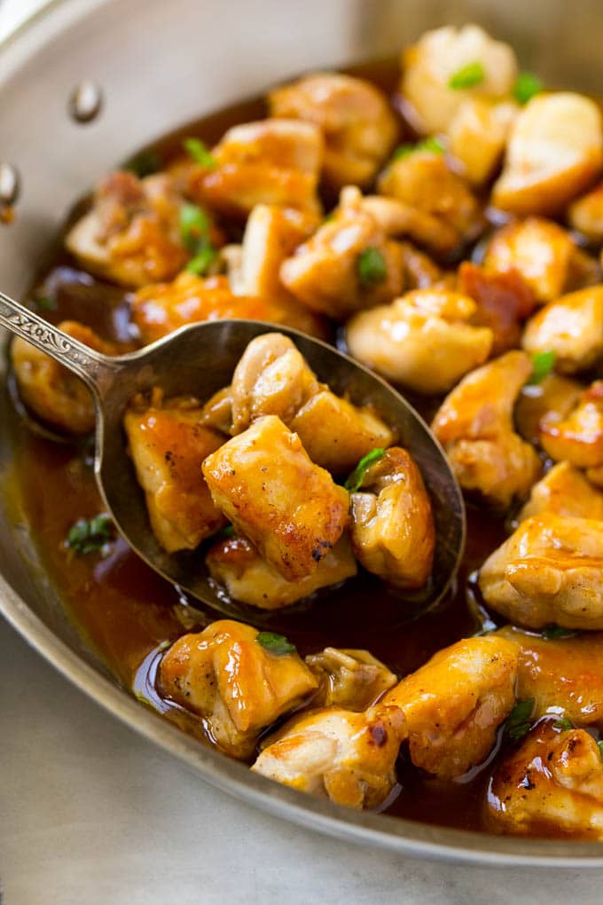 Bourbon Chicken | Sauteed Chicken | Chicken Stir Fry | Easy Chicken Recipe #chicken #dinner #uzhal A pan of bourbon chicken with a serving spoon in it.