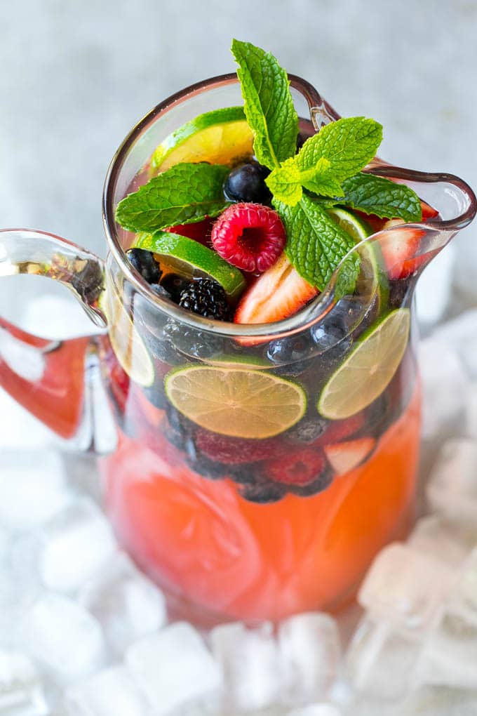 Berry Champagne Punch Recipe | Champagne Cocktail | Lime Cocktail | Berry Punch | Champagne Recipe #champagne #punch #berries #drink #uzhal A pitcher of champagne punch filled with fresh berries and mint sprigs.