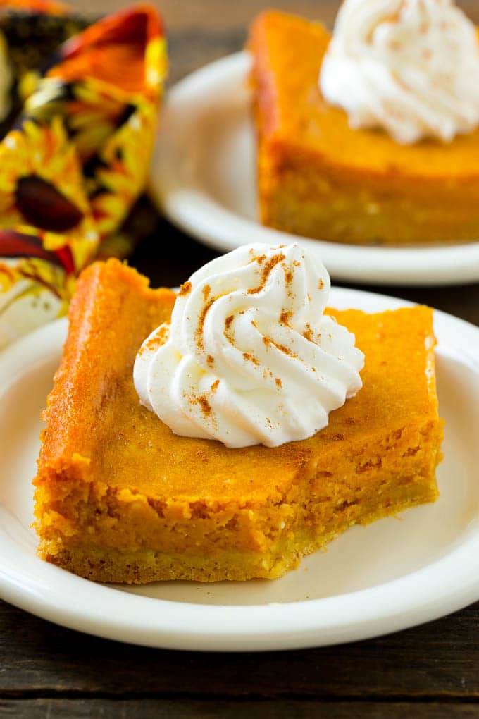 Pumpkin Gooey Butter Cake Recipe | Pumpkin Cake Recipe | Gooey Butter Cake | Pumpkin Dessert | Thanksgiving Dessert #pumpkin #cake #pumpkincake #gooeybuttercake #dessert #uzhal A slice of pumpkin butter cake with a bite taken out of it.
