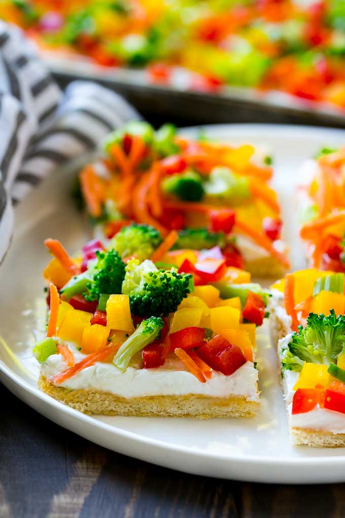 Veggie Pizza Recipe | Crescent Veggie Pizza | Vegetable Pizza Recipe | Holiday Appetizer | Homemade Veggie Pizza #pizza #veggies #vegetarian #appetizer #uzhal Slices of veggie pizza on a serving plate.