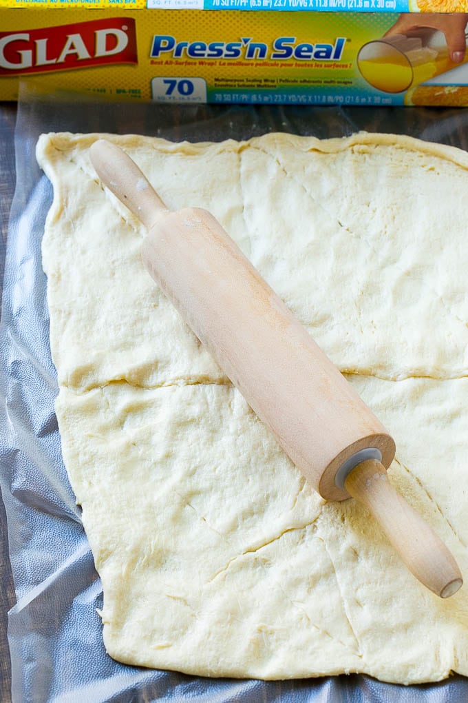 Veggie Pizza Recipe | Crescent Veggie Pizza | Vegetable Pizza Recipe | Holiday Appetizer | Homemade Veggie Pizza #pizza #veggies #vegetarian #appetizer #uzhal Crescent roll dough rolled out into a rectangle.