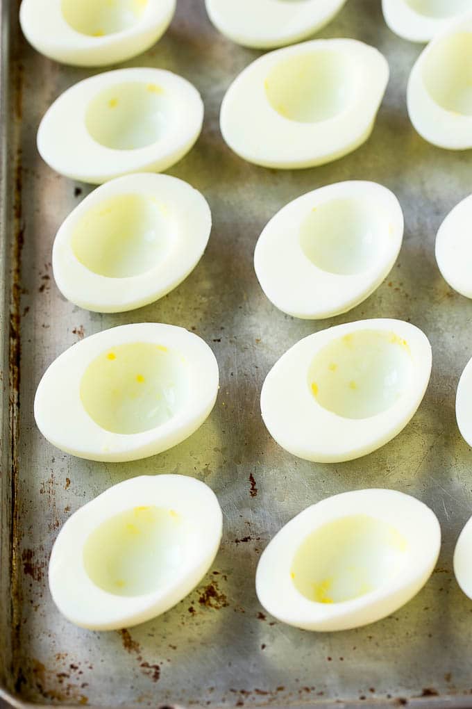 Bacon Deviled Eggs | Deviled Eggs Recipe #eggs #keto #lowcarb #bacon #appetizer #uzhal Egg white halves on a sheet pan.