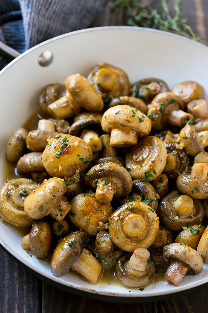 Garlic Mushrooms Recipe | Steakhouse Mushrooms | Sauteed Mushrooms | Garlic Butter Mushrooms | Mushroom Side Dish #mushrooms #butter #keto #lowcarb #dinner #sidedish #uzhal A pan full of cooked mushrooms coated in garlic butter.