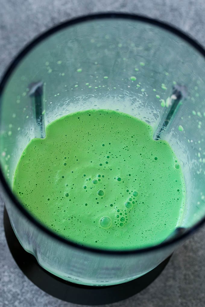 Shamrock Shake Recipe | McDonald's Shamrock Shake | Saint Patrick's Day Drink | Mint Milkshake #milkshake #stpatricksday #saintpatricksday #mint #uzhal Green milkshake in a blender.