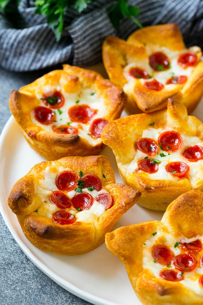 Pizza Muffins Recipe | Pizza Bites | Pizza Cups | Pizza Appetizer #pizza #appetizer #uzhal A plate of pizza muffins made with crescent roll dough, pizza sauce, melted cheese and mini pepperoni.