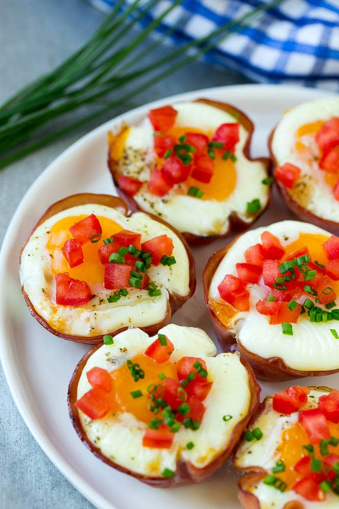 A plate of ham cups filled with eggs and cheese.