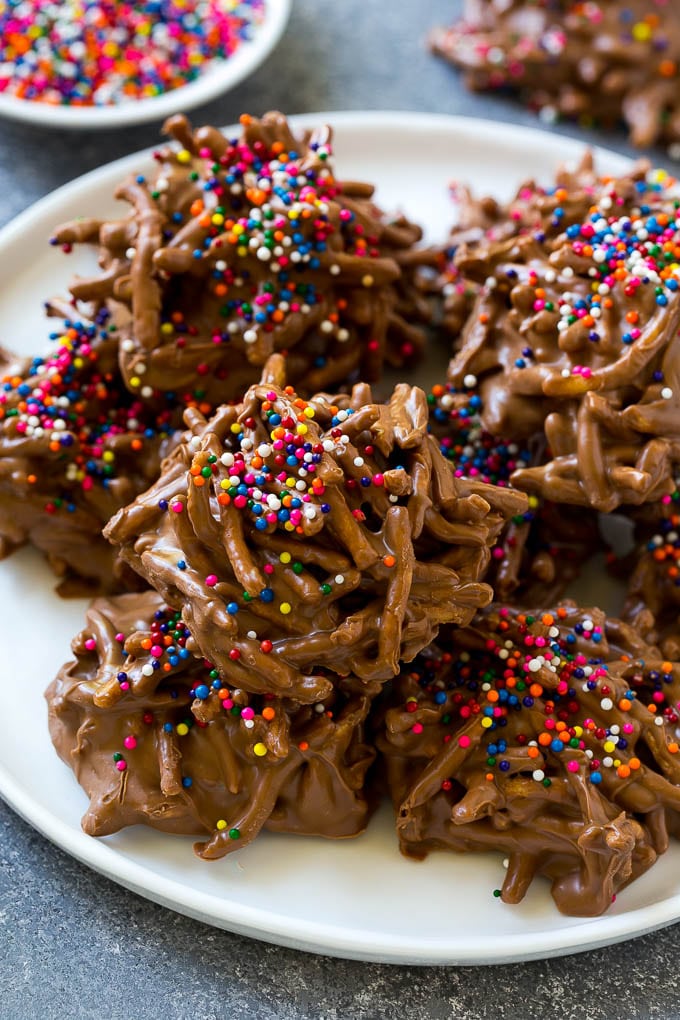 Haystack Cookies Recipe | No Bake Cookies | Chow Mein Noodle Cookies #nobakecookies #cookies #recipe #chocolate #uzhal A plate of haystack cookies topped with rainbow sprinkles.