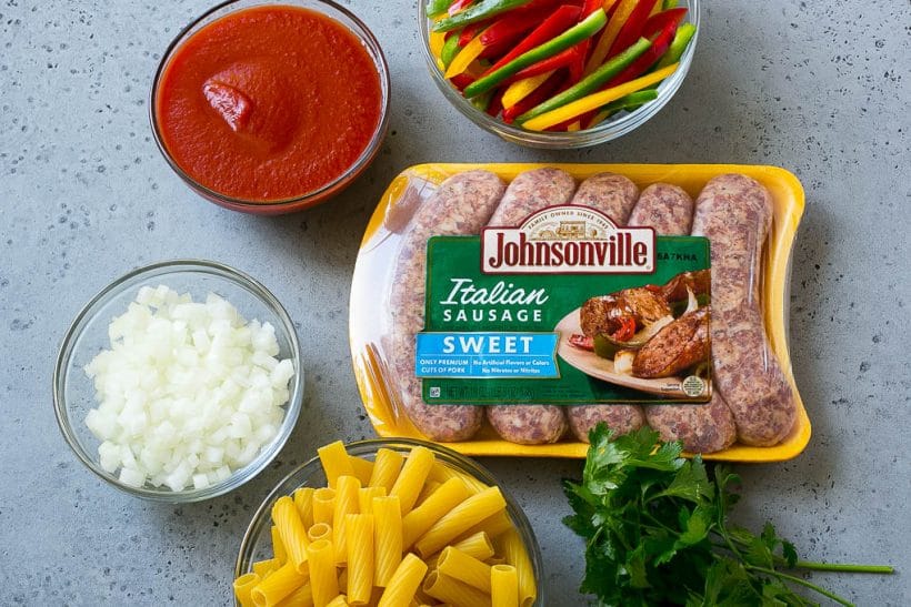 Ingredients like pork, tomato sauce onion and rigatoni. 