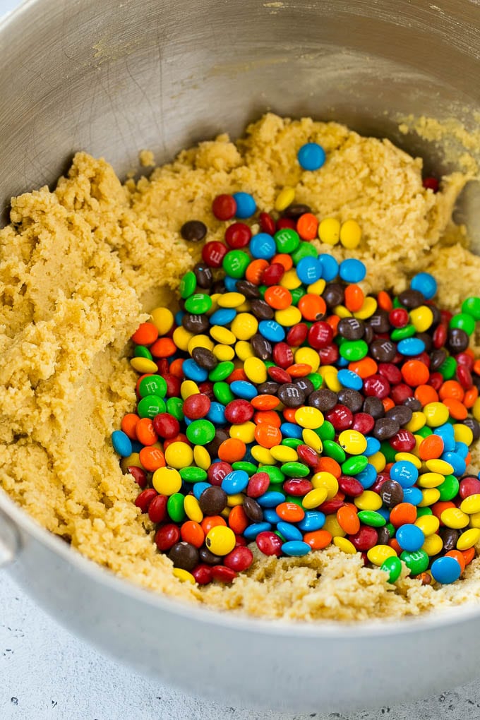 Oreo Stuffed Cookies Recipe | M&M's cookies | Stuffed Cookies #cookies #chocolate #oreos #dessert #baking #uzhal Cookie dough in a mixing bowl with miniature M&M's in it.