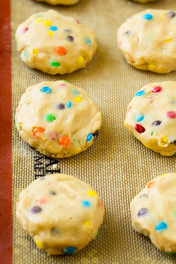 Oreo Stuffed Cookies Recipe | M&M's cookies | Stuffed Cookies #cookies #chocolate #oreos #dessert #baking #uzhal Cookie dough balls stuffed with Oreo cookies on a sheet pan.