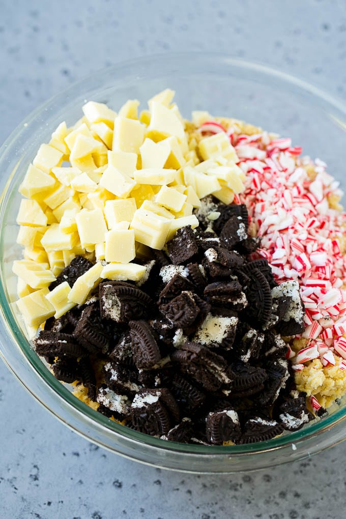 Oreo Peppermint Cookies Recipe | Candy Cane Cookies | Oreo Cookies #oreo #peppermint #cookies #baking #Christmas #sweets #uzhal A bowl of dough with Oreo pieces, white chocolate chunks and crushed candy canes.