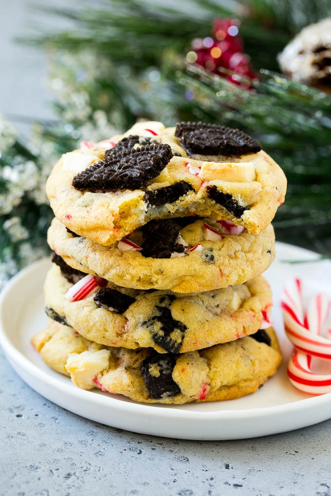 Oreo Peppermint Cookies Recipe | Candy Cane Cookies | Oreo Cookies #oreo #peppermint #cookies #baking #Christmas #sweets #uzhal A stack of Oreo peppermint cookies on a plate, garnished with candy canes.