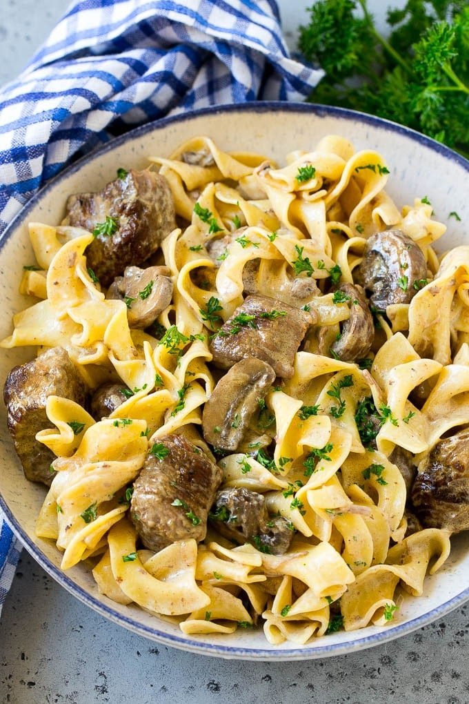 Slow Cooker Beef Stroganoff Recipe | Crock Pot Beef Stroganoff | Beef Recipe #slowcooker #crockpot #beef #mushrooms #pasta #dinner #uzhal A bowl of slow cooker beef stroganoff with egg noodles.