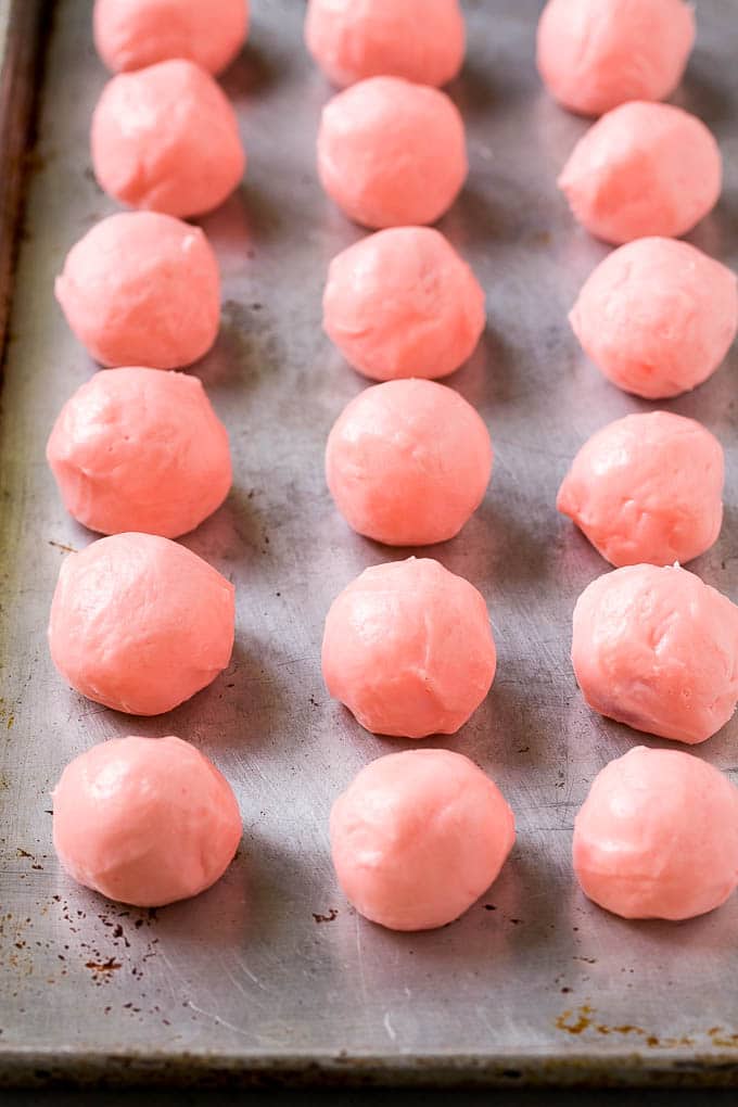 Pink fondant wrapped maraschino cherries.