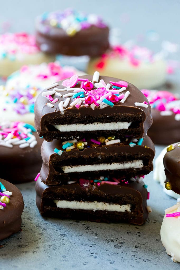 Chocolate Covered Oreos Recipe | Oreo Cookies | Chocolate Dipped Oreos #oreo #cookies #chocolate #sprinkles #dessert #uzhal Three chocolate covered Oreos stacked on top of each other.