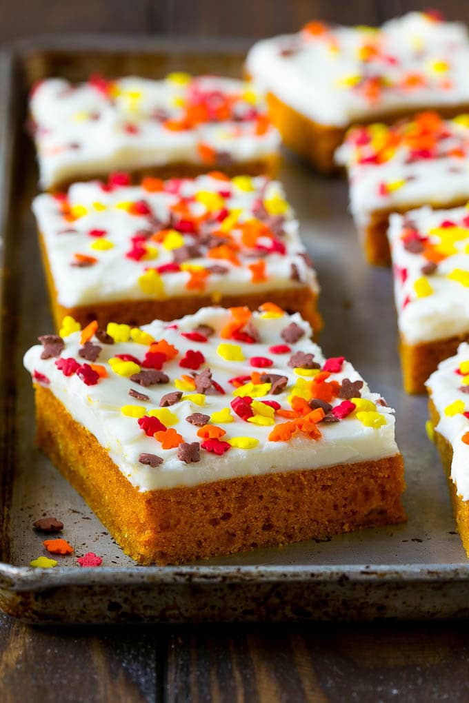 Pumpkin Bars Recipe | Pumpkin Cake | Pumpkin Dessert #pumpkin #fall #dessert #uzhal #thanksgiving A baking sheet of frosted pumpkin bars.