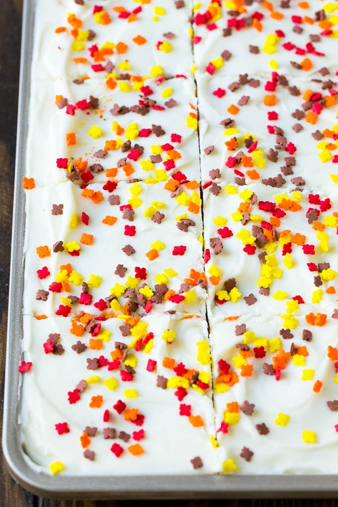 Pumpkin Bars Recipe | Pumpkin Cake | Pumpkin Dessert #pumpkin #fall #dessert #uzhal #thanksgiving Cream cheese frosting and sprinkles spread over cake.