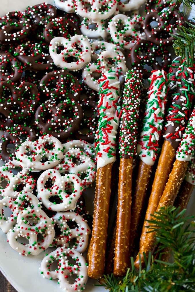 Chocolate Covered Pretzels Recipe | Sprinkle Pretzels | No Bake Dessert #pretzels #chocolate #christmas #sprinkles #candy #uzhal Chocolate covered pretzel twists and rods on a serving platter.