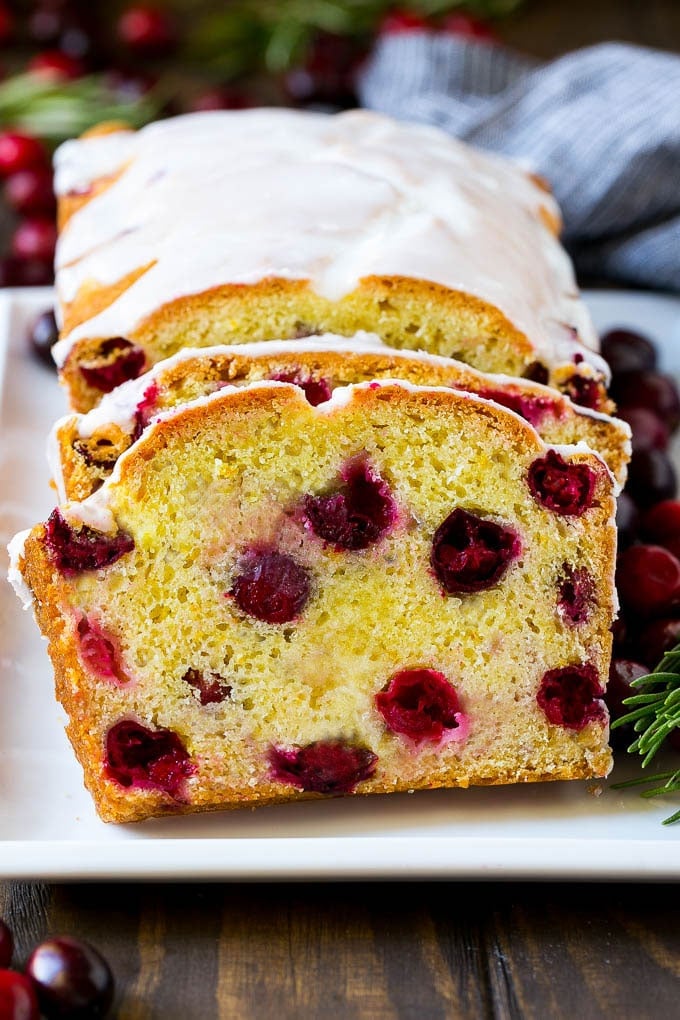 Cranberry Bread Recipe | Cranberry Loaf | Cranberry Orange Bread #cranberry #bread #baking #dessert #fall #uzhal Sliced cranberry bread on a serving plate.