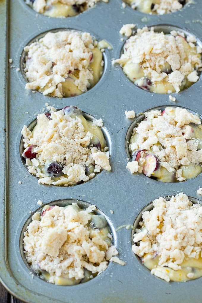 Cranberry Muffins Recipe | Cranberry Orange Muffins #cranberry #muffins #orange #fall #dessert #uzhal Muffins topped with streusel ready to go into the oven.