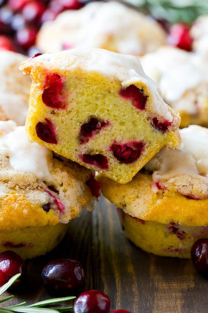 Cranberry Muffins Recipe | Cranberry Orange Muffins #cranberry #muffins #orange #fall #dessert #uzhal A stack of cranberry muffins with one muffin cut in half.