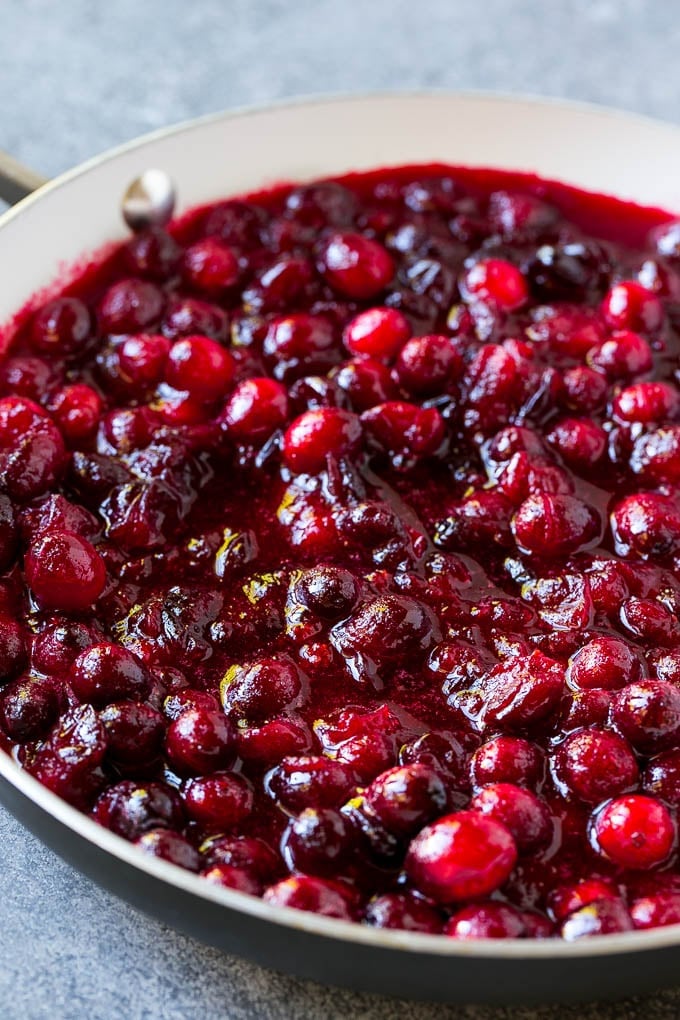 Cranberry Orange Sauce Recipe | Homemade Cranberry Sauce | Fresh Cranberry Sauce #cranberry #orange #fall #thanksgiving #sauce #dinner #uzhal Cranberry orange sauce simmering in a skillet.