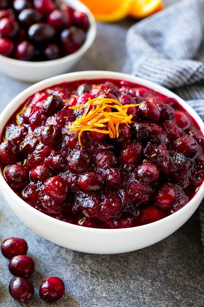 Cranberry Orange Sauce Recipe | Homemade Cranberry Sauce | Fresh Cranberry Sauce #cranberry #orange #fall #thanksgiving #sauce #dinner #uzhal A bowl of cranberry orange sauce topped with fresh orange zest.