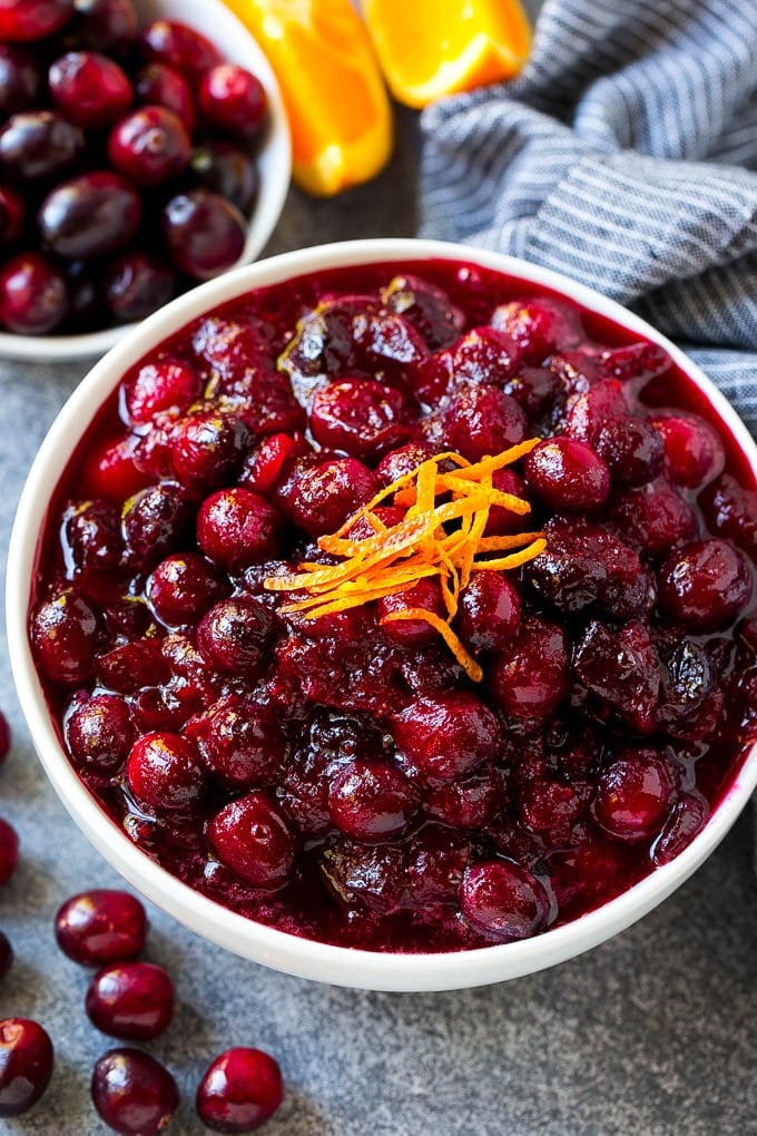 Cranberry Orange Sauce Recipe | Homemade Cranberry Sauce | Fresh Cranberry Sauce #cranberry #orange #fall #thanksgiving #sauce #dinner #uzhal Cranberry orange sauce, topped with fresh orange zest in a serving bowl.