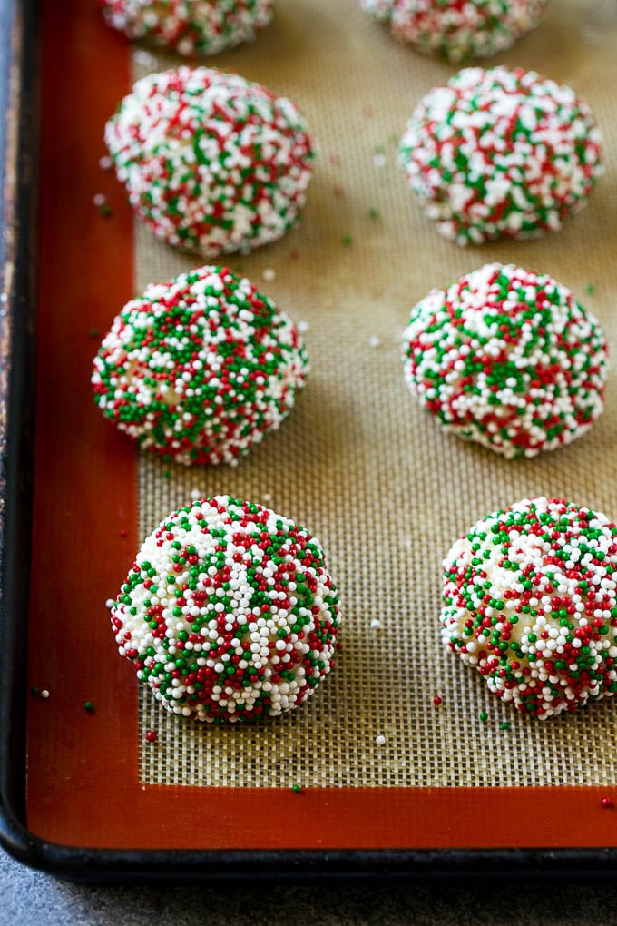 Gooey Butter Cookies Recipe | Cake Mix Cookies | Sprinkle Cookies | Christmas Cookies #cookies #butter #sprinkles #christmas #dessert #baking #uzhal Balls of dough rolled in sprinkles.