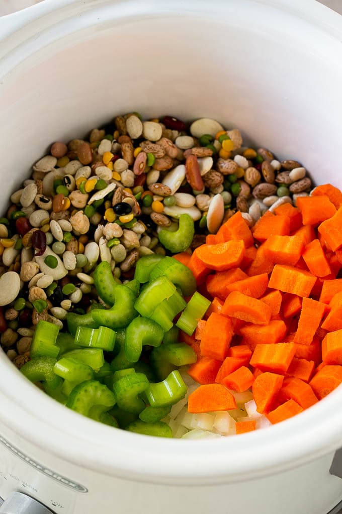 Ham and Bean Soup Recipe | Slow Cooker Ham and Bean Soup | Crockpot Ham and Bean Soup | Leftover Ham Recipe #ham #beans #soup #slowcooker #crockpot #dinner #uzhal Dried beans, carrots, onions and celery in the slow cooker.