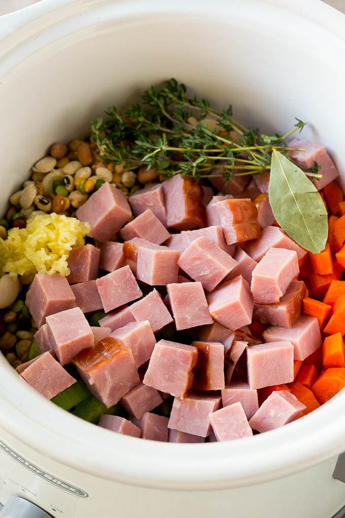 Ham and Bean Soup Recipe | Slow Cooker Ham and Bean Soup | Crockpot Ham and Bean Soup | Leftover Ham Recipe #ham #beans #soup #slowcooker #crockpot #dinner #uzhal Vegetables, pork, herbs and garlic in the slow cooker.