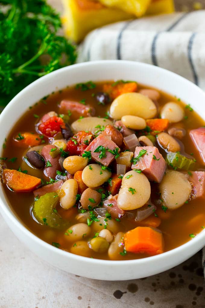 Ham and Bean Soup Recipe | Slow Cooker Ham and Bean Soup | Crockpot Ham and Bean Soup | Leftover Ham Recipe #ham #beans #soup #slowcooker #crockpot #dinner #uzhal A bowl of ham and bean soup made with dried beans, ham and vegetables, then topped with fresh parsley.