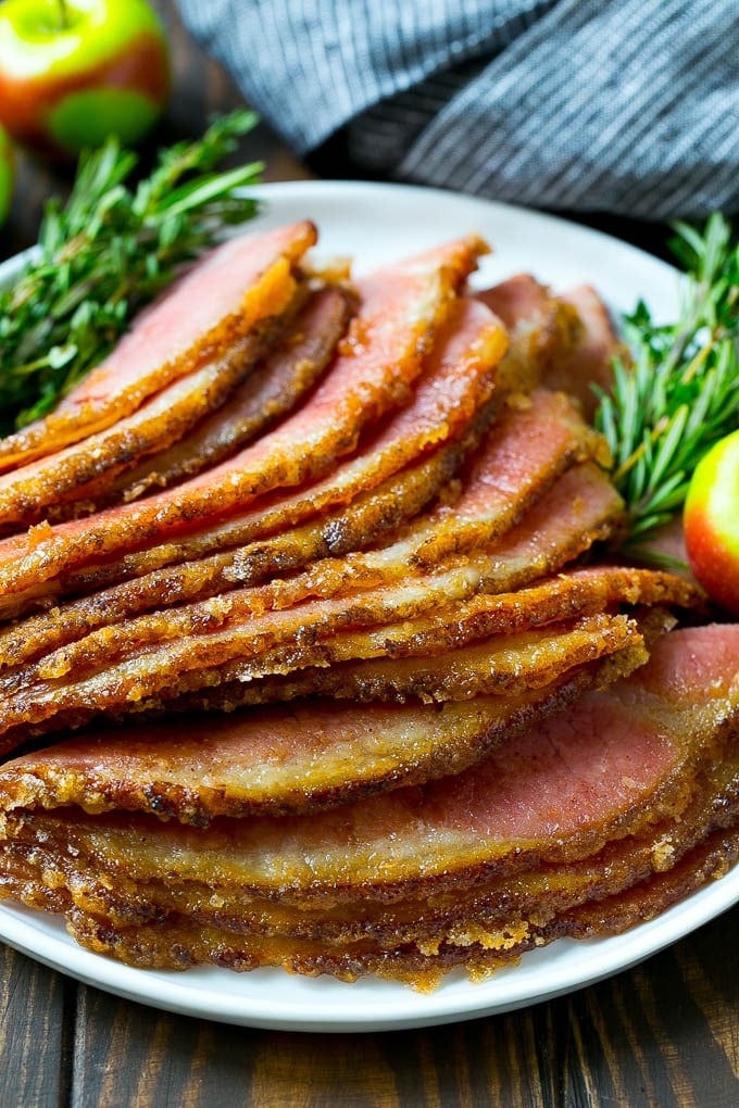 Honey Baked Ham Recipe | Glazed Ham | Holiday Ham #ham #dinner #uzhal #christmas #thanksgiving #easter Sliced honey baked ham on a serving plate.