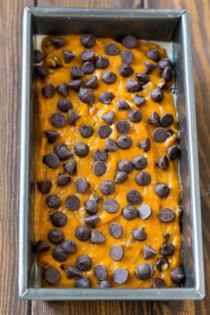 Pumpkin Chocolate Chip Bread Recipe | Pumpkin Bread | Chocolate Pumpkin Bread #pumpkin #bread #fall #chocolate #baking #dessert #uzhal A loaf pan of pumpkin chocolate chip bread batter.